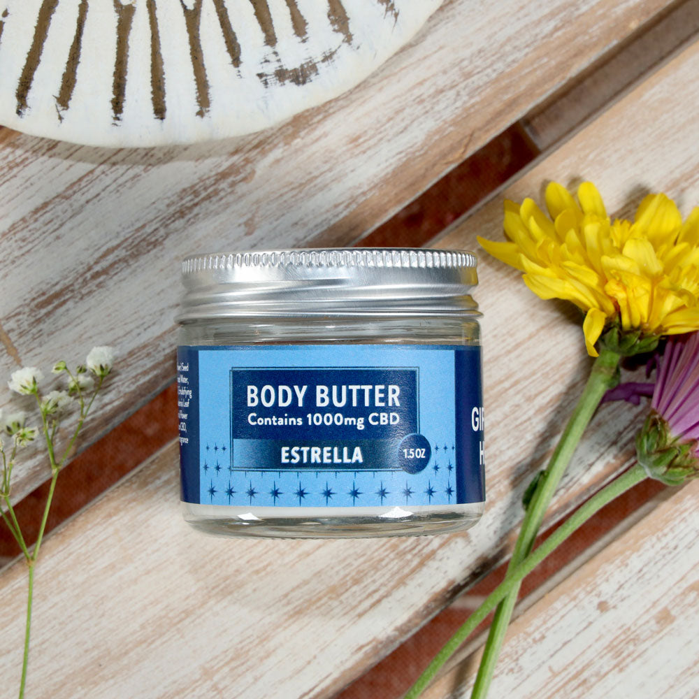 Jar of Body Butter - Estrella shown on a wooden surface