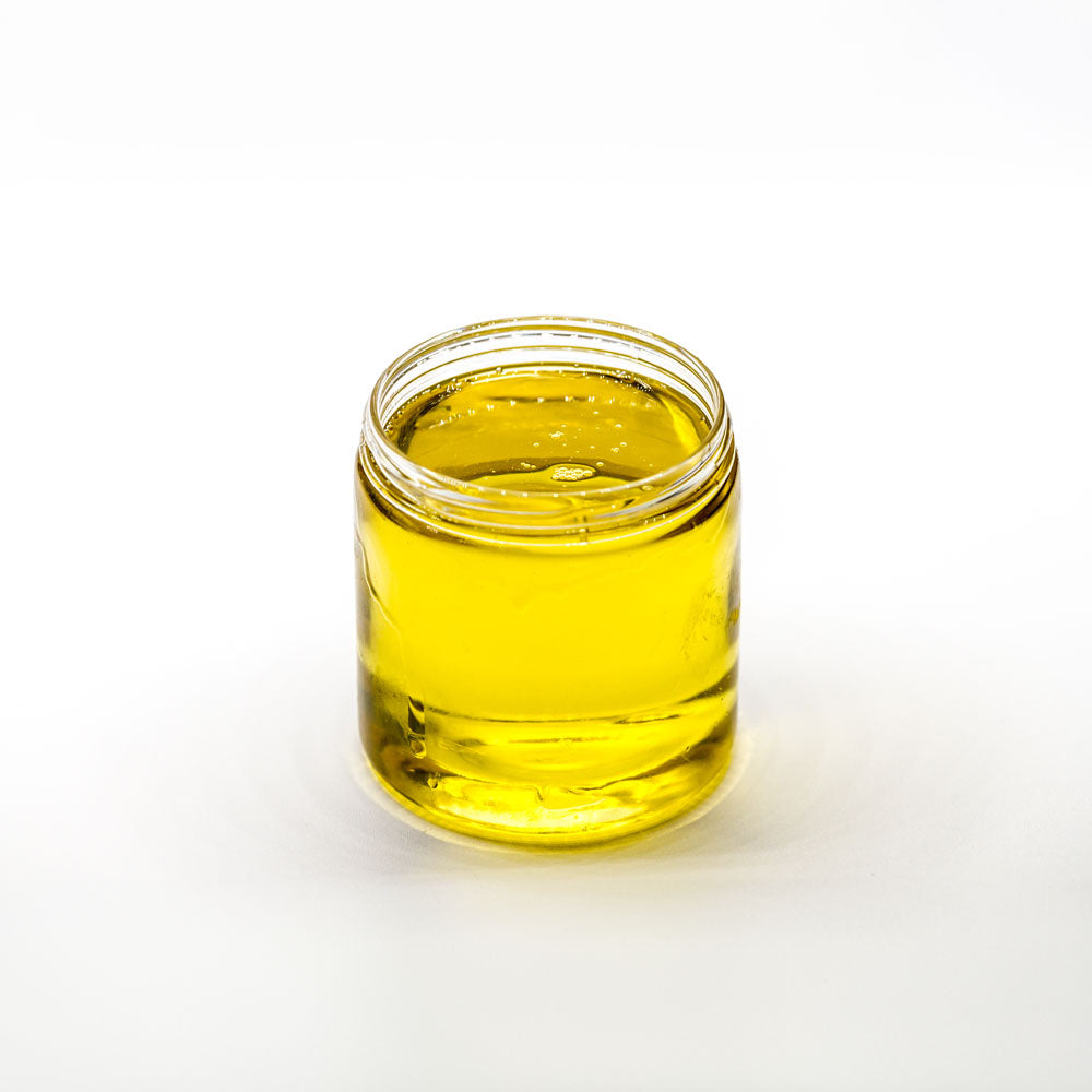 Small Jar of Hemp Extract Massage Oil on a white background